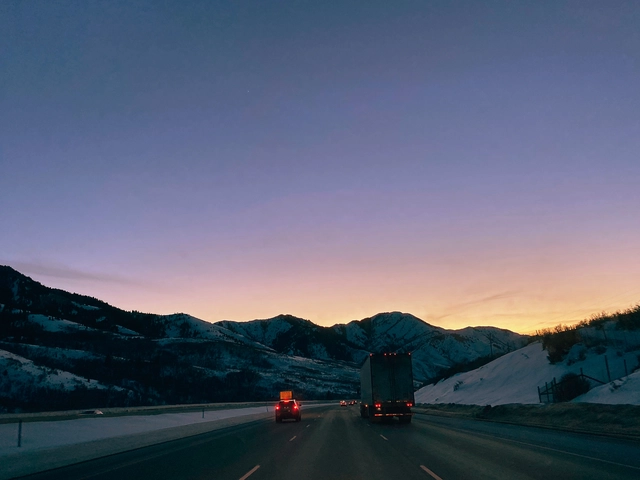 Cars driving during sunset on a winter highway